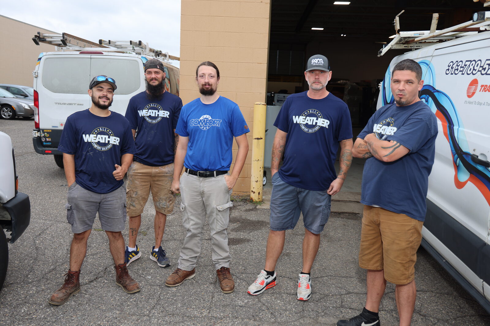 The All Weather Comfort Solutions crew standing with the company vans
