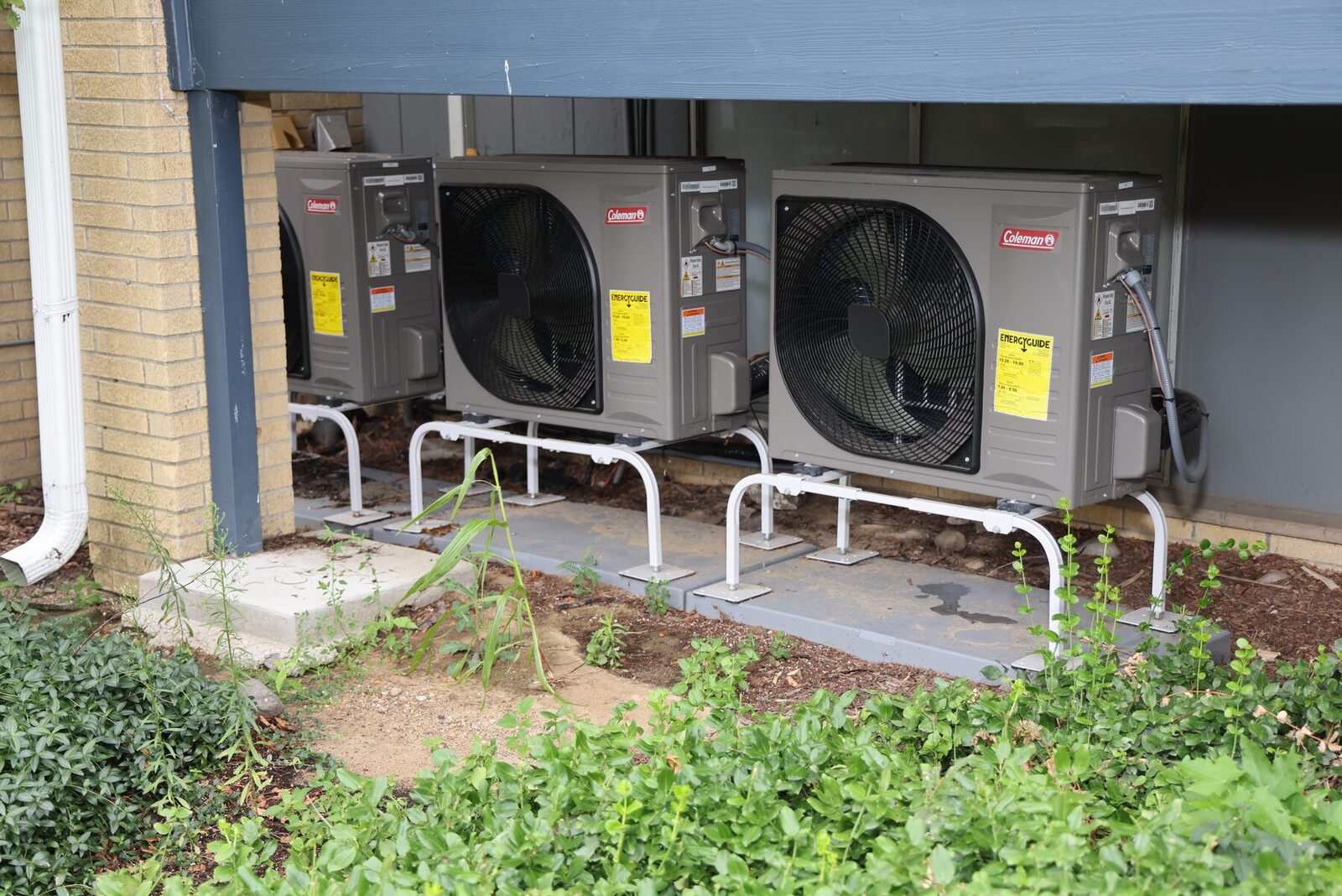 Two freshly installed outdoor HVAC units at a Michigan home